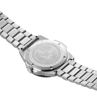 Close-up of a silver watch with engraved design on a white background